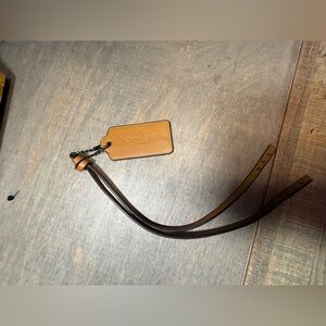 COACH Tan Leather Tag with Adjustable Dark Brown Strap with studs.